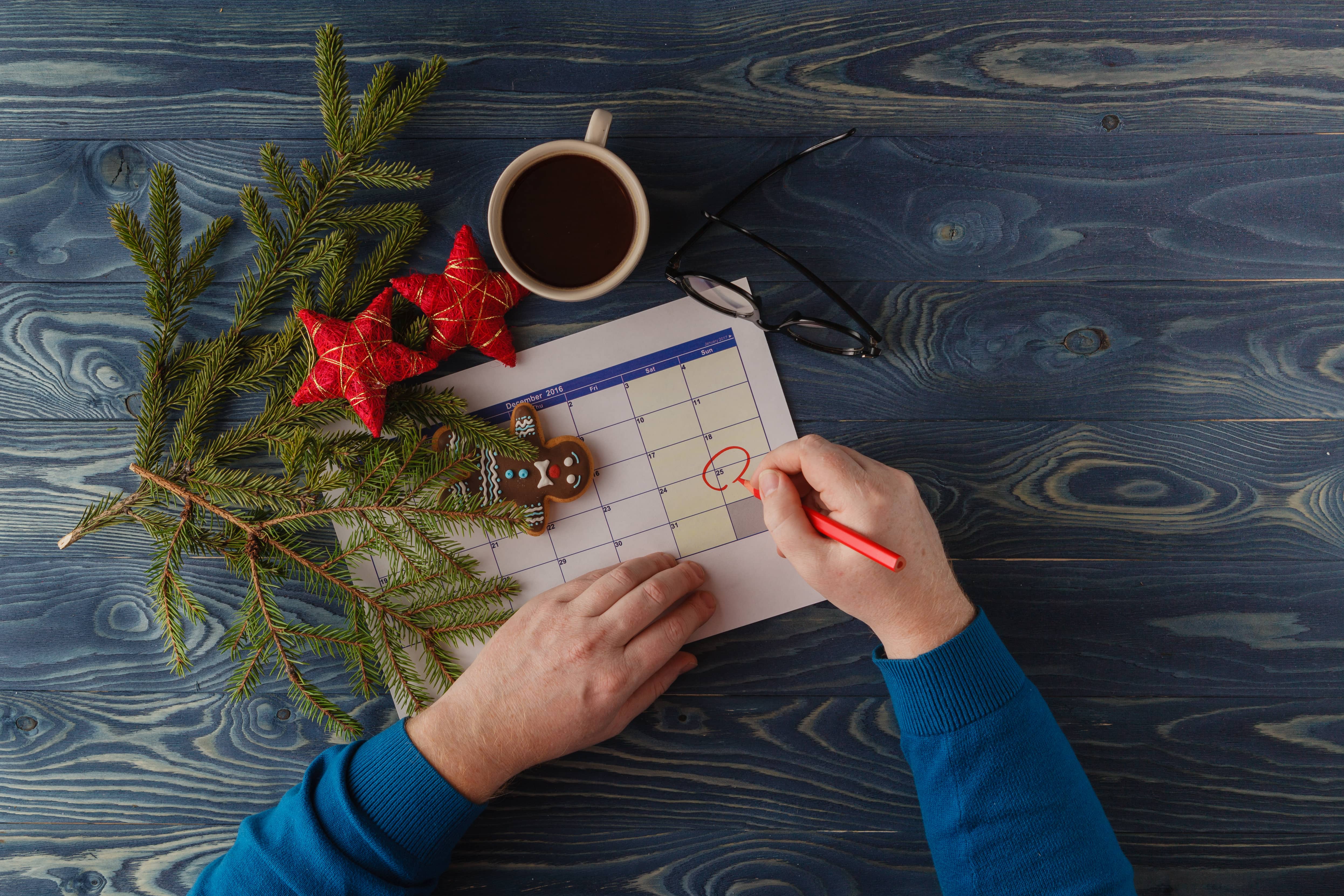 Hand pointing December in a calendar